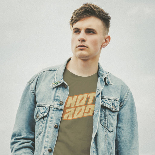 PRODUCT IMAGE: Model with a denim jacket wears Army t-shirt featuring vintage flame graphics with classic hot rod styling to a typographic design