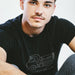 Load Me Up T-shirt | Raunchy T-shirt for Horny Gay Bottom Guys Who Crave Cum | Model wears Black shirt with white line drawing of a dump truck