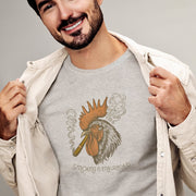 PRODUCT IMAGE: Smokin’ Cock Tee  | Funny, Raunchy T-shirt for Horny Gay Men | Model wears Light Gray Heather shirt with a vintage-style graphic of a rooster smoking a cigar
