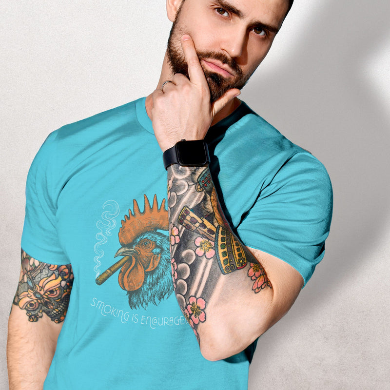 PRODUCT IMAGE: Smokin’ Cock Tee  | Funny, Raunchy T-shirt for Horny Gay Men | Model wears Turquois shirt with a vintage-style graphic of a rooster smoking a cigar