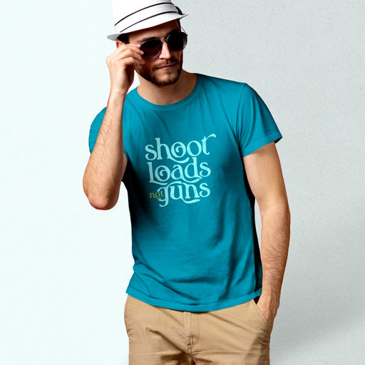 PRODUCT IMAGE: Shoot Loads Not Guns | Conscious and Raunchy T-shirt for Guys into Cum | Model wears Aqua tee with typographic design