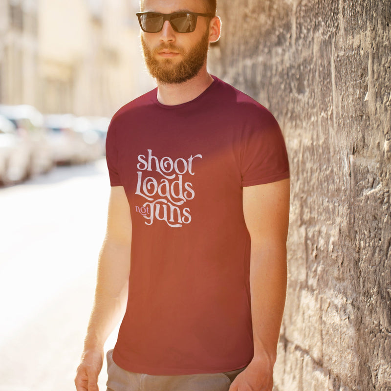 PRODUCT IMAGE: Model wears Aqua tee with typographic design, "Shoot Loads Not Guns" | Conscious and Raunchy T-shirt for Guys into Cum