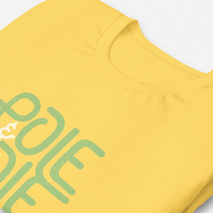 PRODUCT IMAGE: Pole & Hole | SFW, Raunchy Tee for Horny Gay Guys | Detail image of Yellow tee with the shop's typographic trademark 