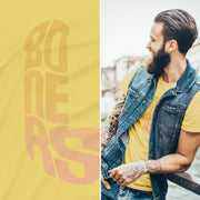 PRODUCT IMAGE: Boners | NSFW Tee | Typographic Design in the form of Cock and Balls | Male model with a blue jean vest smiles and looks away; wears yellow tee