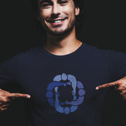 Model wears navy cotton t-shirt with subtle circle graphic of seated male figures holding hands (Circle Jerks), viewed from above; gay-themed design for bators and group play