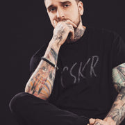 PRODUCT IMAGE | CSKR T-shirt from Pole & Hole | The texting (or sexting) abbreviation for cocksucker | Model w/ Black Shirt