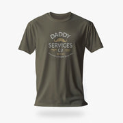 An olive green short-sleeve t-shirt with a vintage-style graphic on the chest reading 'DADDY SERVICES CO' in white and gold, displayed against a clean white background.