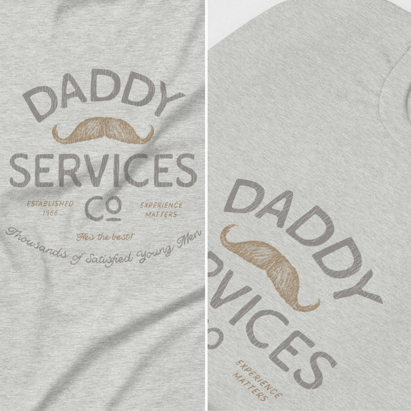 Heather gray t-shirt featuring a vintage-style graphic print that reads 'DADDY SERVICES CO' with a tan mustache illustration and smaller decorative text.
