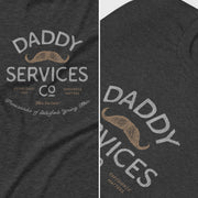 Dark heather gray t-shirt featuring a vintage-style graphic print that reads 'DADDY SERVICES CO' with a tan mustache illustration and smaller text, shown in a split close-up of the front and side views.