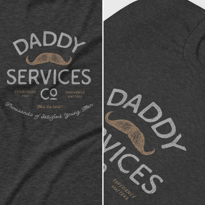 Dark heather gray t-shirt featuring a vintage-style graphic print that reads 'DADDY SERVICES CO' with a tan mustache illustration and smaller text, shown in a split close-up of the front and side views.