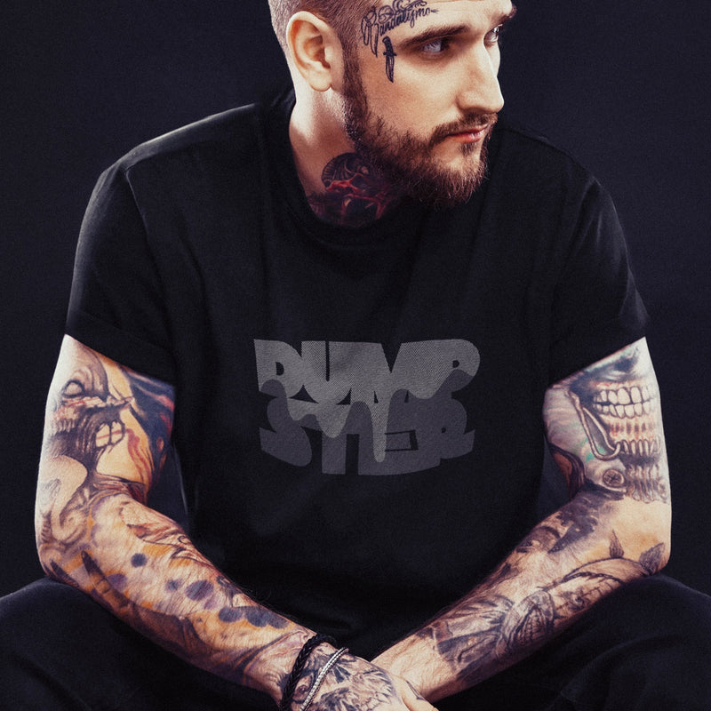 PRODUCT IMAGE: Dumpster T-shirt | Raunchy Tees for Horny Gay Guys Who Take Loads | Model wears Black shirt with a typographic design featuring white dripping liquid referring to a man's cum