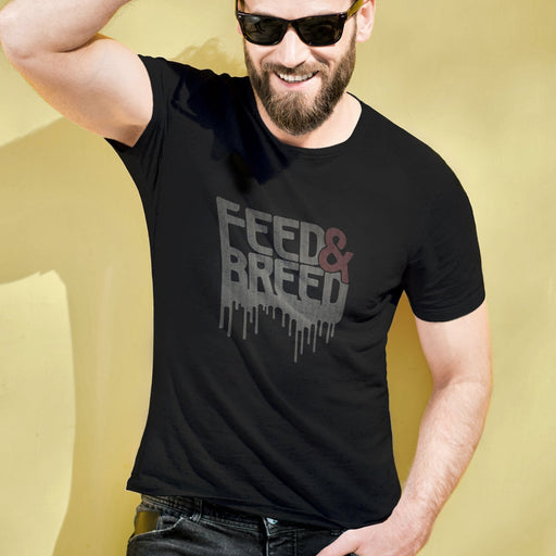 PRODUCT IMAGE: Feed & Breed T-shirt | Raunchy Tees for Horny Gay Guys | Model wears black shirt with typographic design