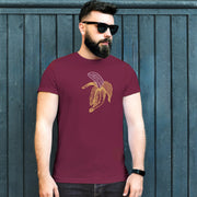 PRODUCT IMAGE: Fresh Fruit T-Shirt | Raunchy Tee for Horny Gay Men & Size Queens | Model wears Maroon shirt with a woodcut-style graphic of a colorful banana