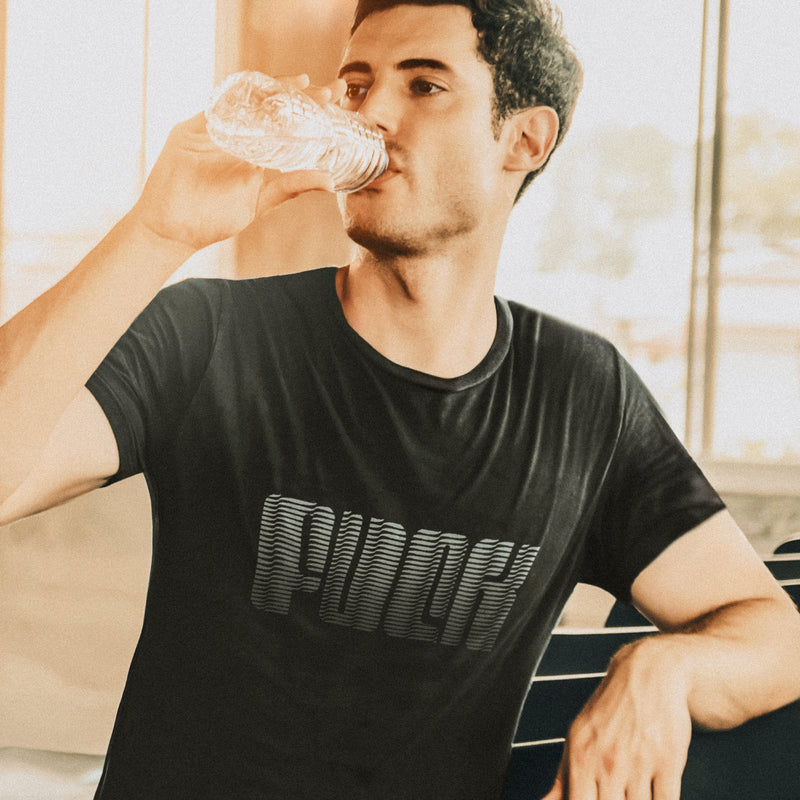 PRODUCT IMAGE: Fuck | Offensive NSFW T-shirt for Horny Gay Guys | Typographic Design | Model w/ Black tee with typographic design