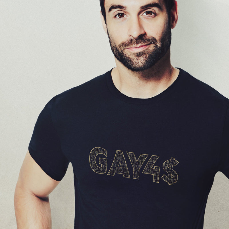 Model wears black GAY4$ shirt with bold, bling-inspired typography — a cheeky, provocative tee for queer men and hustlers alike.