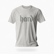 PRODUCT IMAGE: Hard T-Shirt | Raunchy Graphic Tee for Horny Gay Men into big boners, hard cocks, and erections | Light Gray Heather shirt with a design created with blackletter / gothic typography