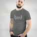 PRODUCT IMAGE: Hard T-Shirt | Raunchy Graphic Tee for Horny Gay Men into big boners, hard cocks, and erections | Model wears Charcoal shirt with a typographic design created with blackletter / gothic lettering