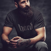 PRODUCT IMAGE: Hard T-Shirt | Raunchy Graphic Tee for Horny Gay Men into big boners, hard cocks, and erections | Dark Gray Heather shirt with a typographic design created with blackletter / gothic lettering