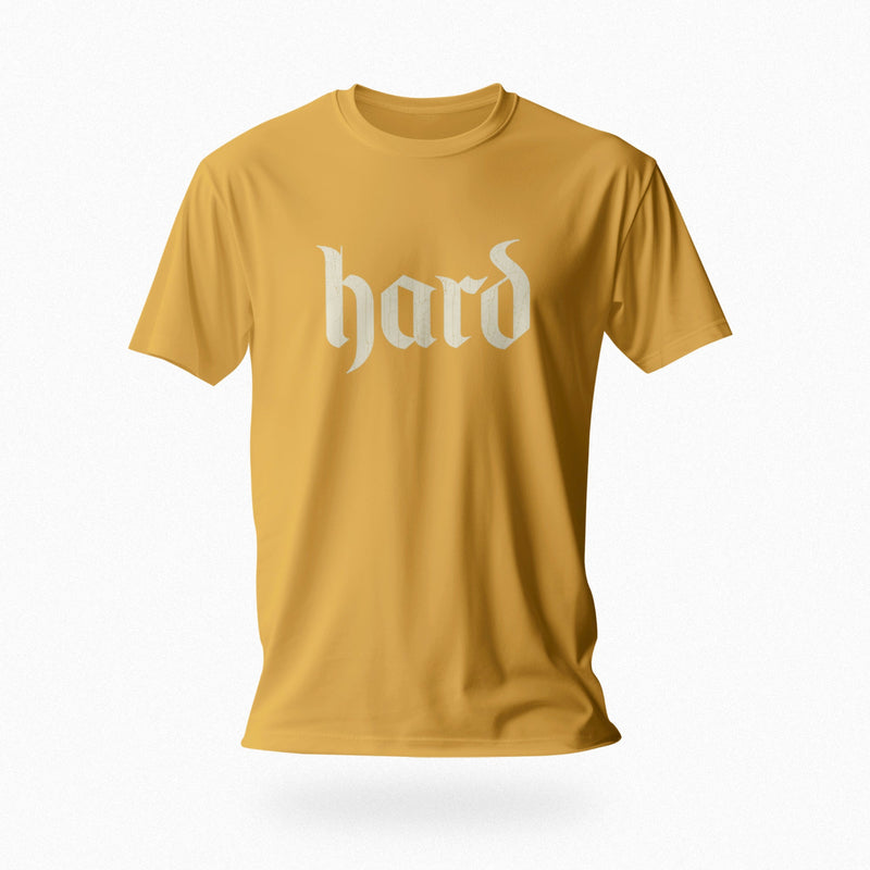 PRODUCT IMAGE: Hard T-Shirt | Raunchy Graphic Tee for Horny Gay Men into big boners, hard cocks, and erections | Mustard shirt with a design created with blackletter / gothic typography