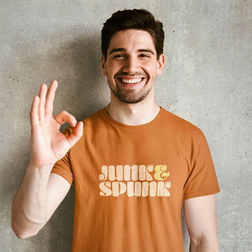 PRODUCT IMAGE: Junk & Spunk T-shirt | Raunchy Tees for Horny Gay Guys | Model wears Orange shirt w/ typographic design