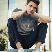 Model wears Charcoal shirt with a woodcut-style linedrawing of a pink pig with typography below, revealing the design's name, "This ‘Lil Piggy T-shirt"; Funny Gay SFW Tee for Horny Gay Guys Who are Quietly Nasty Pigs