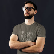 PRODUCT IMAGE: He Likes It Nice & Slow T-shirt | Funny Gay Tee for the guys who take their time and enjoy the ride | Model wears Charcoal shirt with a design borne out of retro-inspired typography