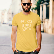 PRODUCT IMAGE: He Likes It Nice & Slow T-shirt | Funny Gay Tee for the guys who take their time and enjoy the ride | Model wears Yellow shirt with a design borne out of retro-inspired typography