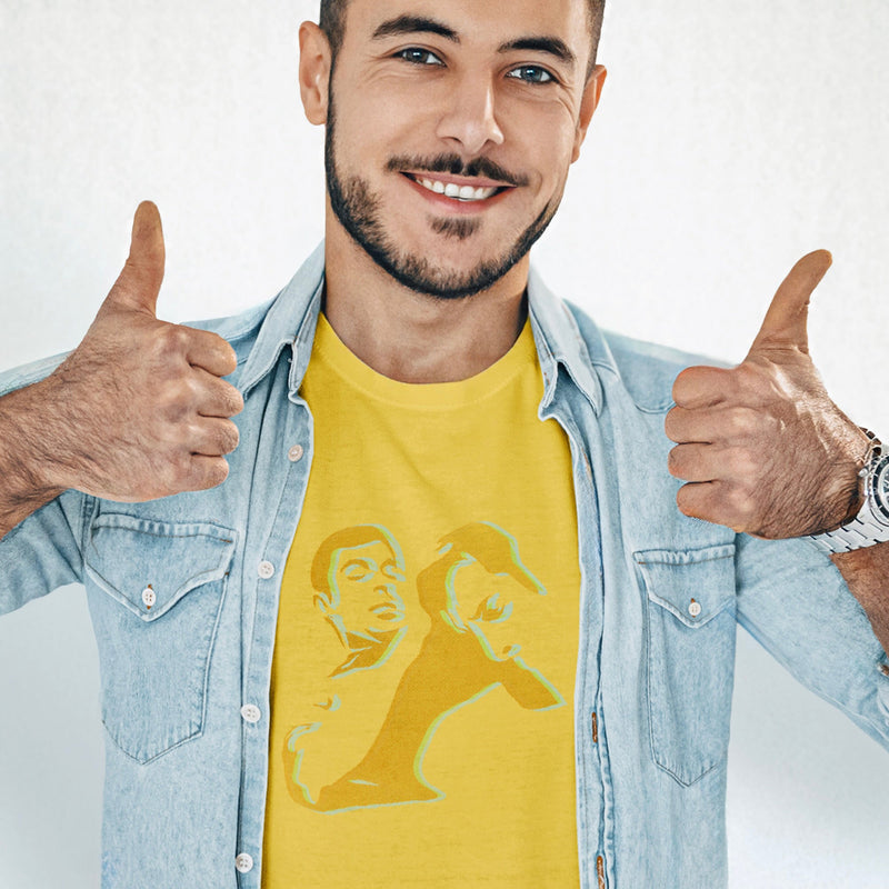 Male model wearing a yellow Nosh T-shirt featuring an abstract homoerotic graphic illustration, styled with a denim shirt and giving a thumbs-up.