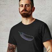 PRODUCT IMAGE: Certified Organic T-shirt | Raunchy Penis T-shirts for Horny Gay Men | Model wears Black shirt with a woodcut-style rendering of the eggplant emoji