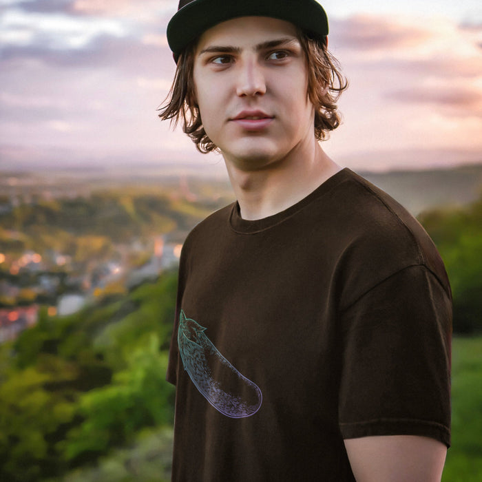 PRODUCT IMAGE: Certified Organic T-shirt | Raunchy Penis T-shirts for Horny Gay Men | Model wears Brown shirt with a woodcut-style rendering of the eggplant emoji