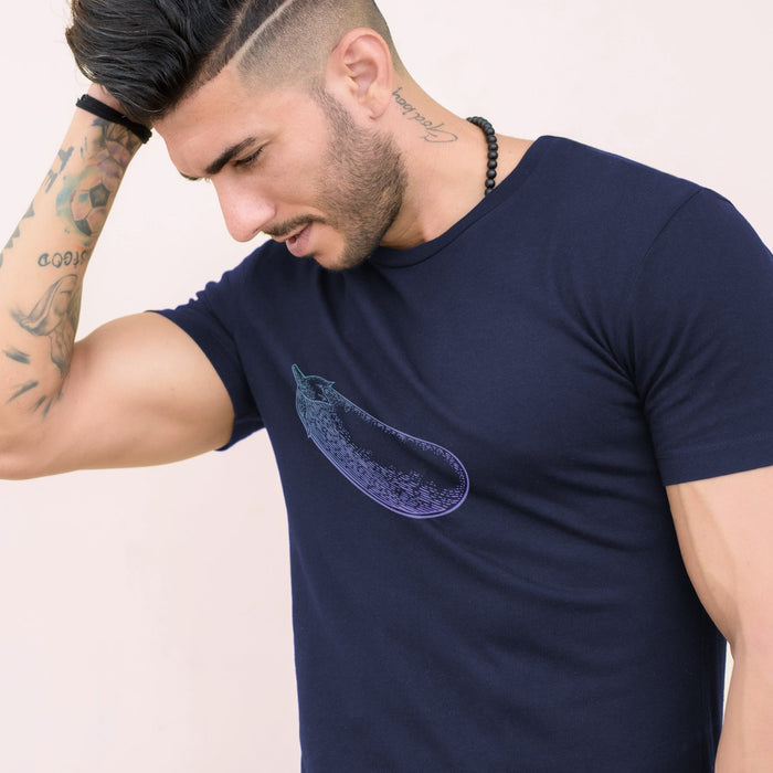 PRODUCT IMAGE: Certified Organic T-shirt | Raunchy Penis T-shirts for Horny Gay Men | Model wears Navy shirt with a woodcut-style rendering of the eggplant emoji