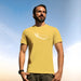 PRODUCT IMAGE: Certified Organic T-shirt | Raunchy Penis T-shirts for Horny Gay Men | Model wears Yellow shirt with a woodcut-style rendering of the eggplant emoji