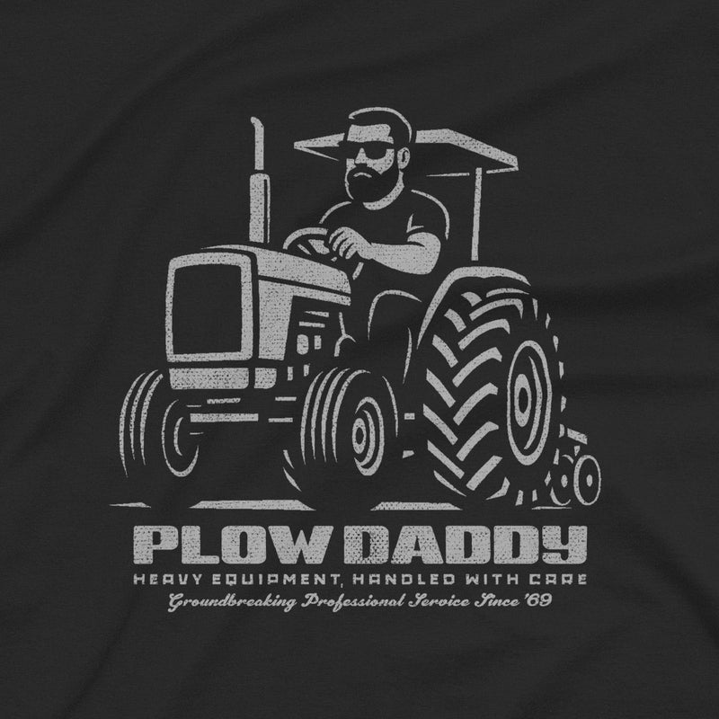 PRODUCT IMAGE: Plow Daddy T-shirt | Raunchy Gay Farmer Tee for Horny Men Who Love Heavy Equipment | Close-up view of the graphic on a Black shirt