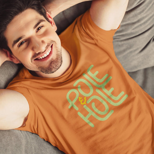 PRODUCT IMAGE: Pole & Hole | SFW, Raunchy Tee for Horny Gay Guys | Model wears Orange tee with the shop's typographic trademark 