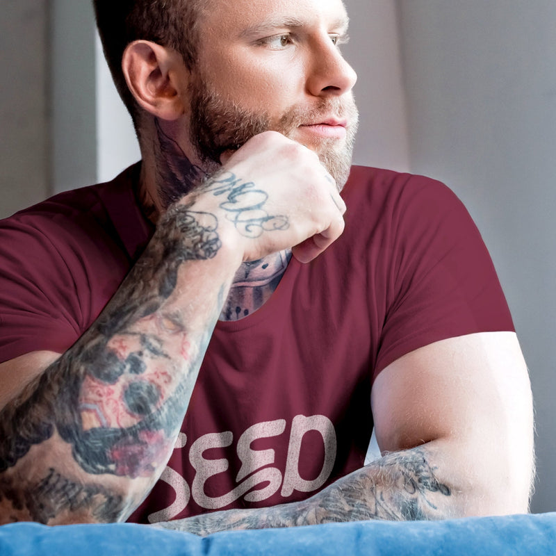 Seed | Marginally SFW Tee for Horny Gay Guys Into Cum | Model wear Maroon tee with typographic design