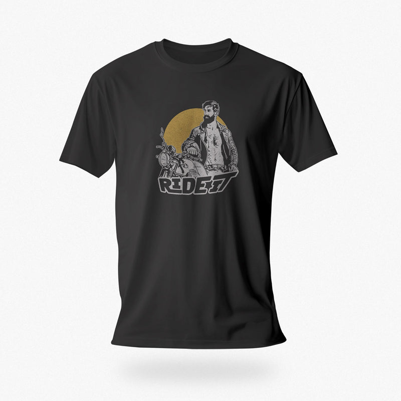 PRODUCT IMAGE of a dark gray t-shirt with a graphic featuring a rugged, bearded biker in a distressed vintage print style with the design's namesake, "Ride It."