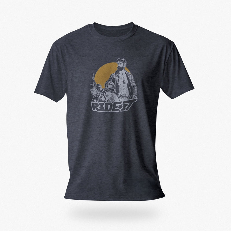 PRODUCT IMAGE of a navy heather t-shirt with a graphic featuring a rugged, bearded biker in a distressed vintage print style with the design's namesake, "Ride It."