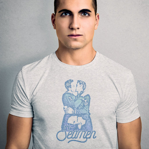 PRODUCT IMAGE: Seamen | Seamen T-shirt | Raunchy T-shirts Play on Word "Semen" | Model wears light gray heather shirt | Modeled from a vintage photo of two gay male sailors kissing. Seamen is a homonym, playing on the word — yep, you guessed it — semen. 