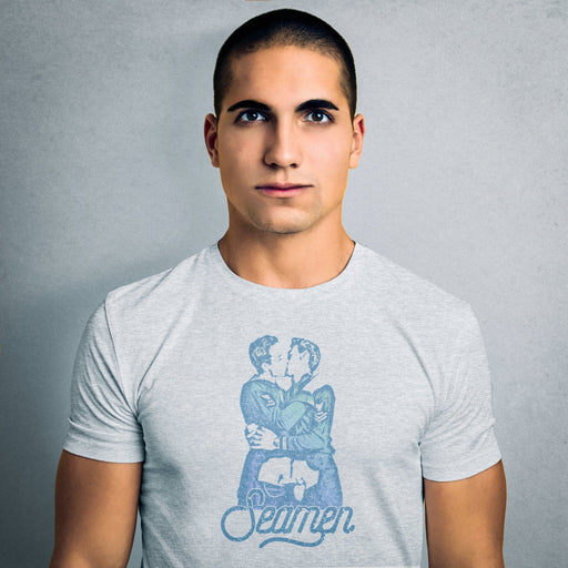 PRODUCT IMAGE: Seamen | Seamen T-shirt | Raunchy T-shirts Play on Word "Semen" | Model wears light gray heather shirt | Modeled from a vintage photo of two gay male sailors kissing. Seamen is a homonym, playing on the word — yep, you guessed it — semen. 