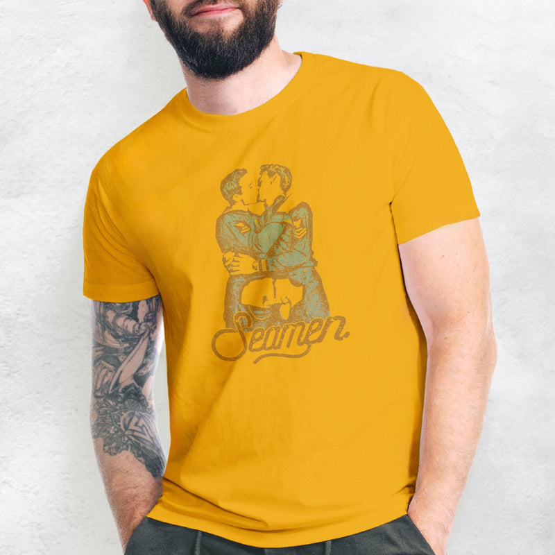 PRODUCT IMAGE: Seamen T-shirt  | Funny, Raunchy T-shirt for Horny Gay Men | Model wears Gold shirt with a design derived from a vintage photo of gay sailors kissing