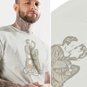 DIPTYCH PRODUCT IMAGE: Seamen | Seamen T-shirt | Raunchy T-shirts Play on Word "Semen" | On left, model wears silver shirt; on the right, a close-up of just the shirt and printed graphic | Modeled from a vintage photo of two gay male sailors kissing. Seamen is a homonym, playing on the word — yep, you guessed it — semen. 