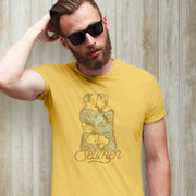 This image features a striking yellow t-shirt with a graphic design inspired by a vintage photo of two male sailors. The design, which plays on the homophone "seamen," incorporates phallic elements and is printed using water-based, vegan inks.