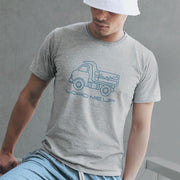 Load Me Up T-shirt | Raunchy T-shirt for Horny Gay Bottom Guys Who Crave Cum | Model wears Light Gray Heather shirt with white line drawing of a dump truck