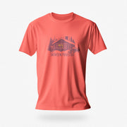 Men’s graphic t-shirt showing a snowy log cabin and plow truck, featuring the phrase “Snowed In, Plowed Out,” a subtle innuendo design for gay men. Product photo shows coral silk tee.