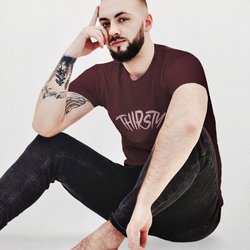 PRODUCT IMAGE: Thirsty T-shirt | Raunchy Tees for Horny Gay Guys Who Thirst for It | Model wears Oxblood shirt with a typographic design