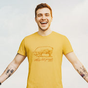 Model wears Mustard t-shirt with a woodcut-style line drawing of a pink pig with typography below, revealing the design's name, "This ‘Lil Piggy T-shirt"; Funny Gay SFW Tee for Horny Gay Guys Who are Quietly Nasty Pigs
