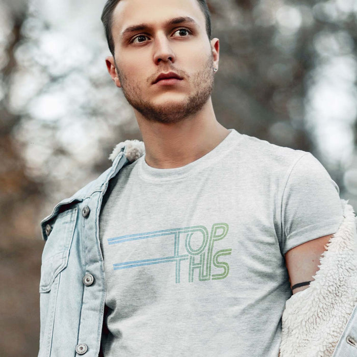 PRODUCT IMAGE: Top This T-shirt | Discreetly Raunchy T-shirt for Horny Gay Bottom Guy | Model wears typographic design on Light Gray Heather shirt